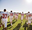© Cavan Images - American football players walking in field