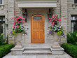 elegant wooden front door of stone house with large flower pots