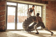 © alfa27 - Muscular african man flipping a tire with a woman on it, working out with weighting