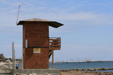 Fototapeta  - Wooden lifeguard hut on a beach