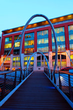 Cool Archway Bridge At Birmingham Canal With A Contrasting, Eye-catching Red Building In The Evening Sky