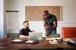© Cavan Images - Two men talking in office