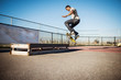 © Cavan Images - Man jumping on skateboard