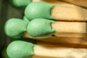 wooden matches with green sulfur head, macro abstraction