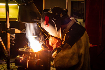 Wall Mural - Electric welding. Electric welder works. The welding process at the factory. Welding metals. Metal processing. Metalworking. Metallurgy.