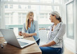 © Cavan Images - Two businesswomen in front of laptop at desk