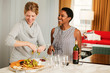 © Cavan Images - Female friends  preparing Hors D'oeuvres