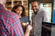 © Cavan Images - Couple paying with credit card in store