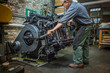 © Cavan Images - Worker pulling lever of printing equipment