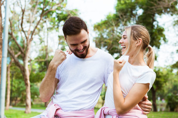 Wall Mural - A couple jogging, cheerful after running as target in the park