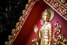 Great Gold Buddha Statue With Red Background Wall.
