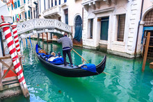 Venetian Gondolier Gondola Through Of Venice. Italy