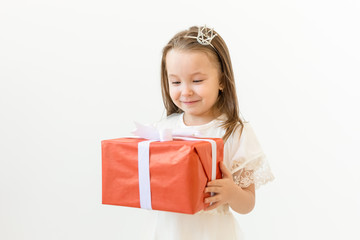 Wall Mural - Holiday and presents concept- Little girl smile and holding red gift box