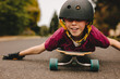 © Jacob Lund - Funny boy with helmet lying on skateboard
