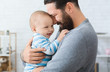 © Prostock-studio - Loving father embracing his cute baby son
