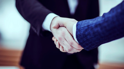 concept of a reliable partnership : a handshake of business partners