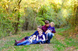© Irina Schmidt - Portrait of young parents with three children. Mother, father, two kids brothers boys and little cute toddler sister girl having fun together in autumn forest. Happy family of five