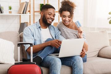 Wall Mural - Romantic couple preparing for travel, using laptop