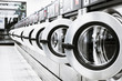 metallic laundry machines standing in a row