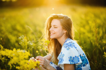 Beautiful girl the flowers field in summer sunset Healthy Lifestyle 