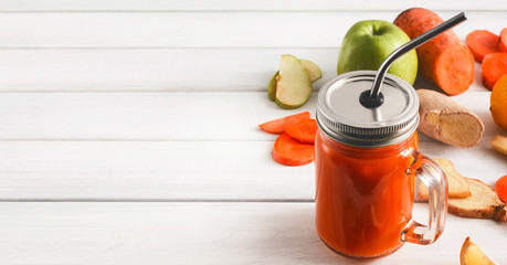 Wall Mural - Natural detox carrot smoothie ingredients on white background