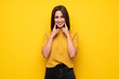 © luismolinero - Young woman over yellow wall smiling with a happy and pleasant expression