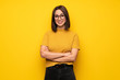 © luismolinero - Young woman over yellow wall with glasses and happy