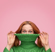 Funny woman pulling sweater neck