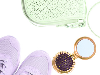 Wall Mural - Leather bag, mini mirror hairbrush, mint-colored sports sneakers isolated on a white background. Women's fashion accessories. Top view.