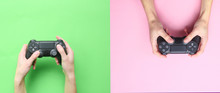 Hands To Use The Gamepad On Green Pink Background. Top View