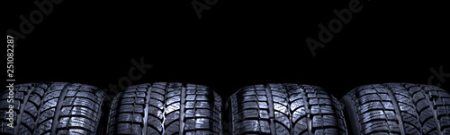 Fotografía Car tires isolated panorama on black background