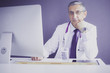 © lenets_tan - Portrait of senior doctor sitting in medical office