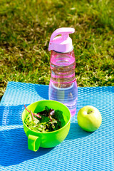 Fresh salad and water - summer lunch after yoga workout