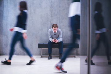 Poster - businessman using mobile phone while sitting on the bench