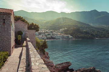 Landscape view of Sveti Stefan, Montenegro. Beautiful mountain and apartments on the seaside