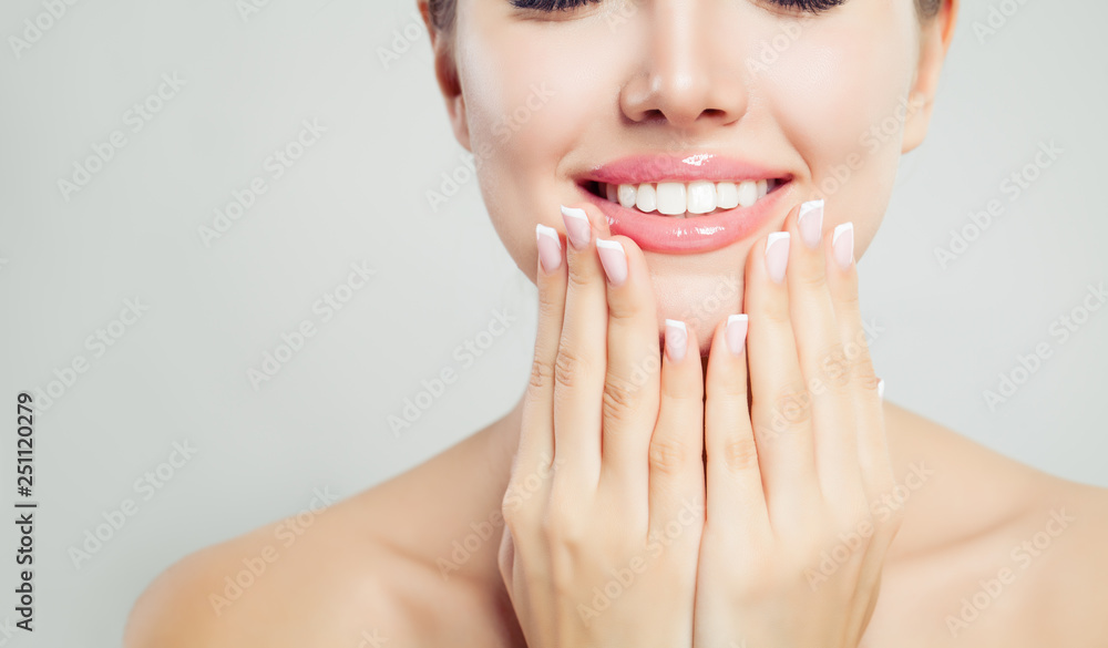Young woman face closeup. Pink glossy female lips with natural makeup and french manicure hands - obrazy, fototapety, plakaty 