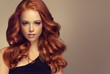 © Sofia Zhuravetc - Beautiful model  girl with long curly red hair .  Styling hairstyles curls .Wavy shiny hair
