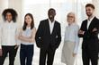 © fizkes - Happy diverse company staff standing posing shooting indoors