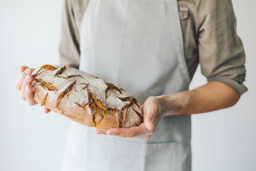 Baker or chef holding fresh made bread