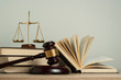 Law concept. Wooden judge gavel with law books ,scales of justice on table in a courtroom or enforcement office.