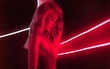canvas print picture - fashion art photo of sexy girl dressed in red in the night-club. Perfect female body with neon lettering on the background