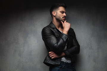 Wall Mural - side view of a pesive man in leather jacket