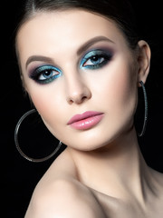 Portrait of beautiful woman with fashion makeup. Modern blue smokey eyes make up. Studio shot