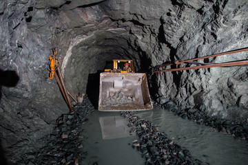 Wall Mural - Underground gold ore mine shaft tunnel gallery passage with load, haul, dump machine LHD