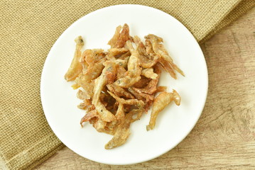 crispy fried anchovy fish with salt on plate