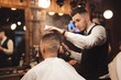 © antgor - Professional barber splashes water on a head of client