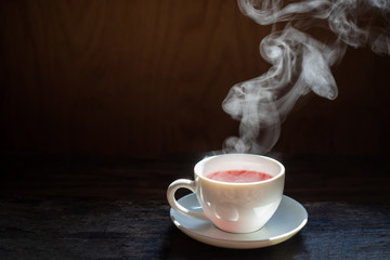 Wall Mural - Hot tea cup in a glass on wood background.Hot drink . Copy space.