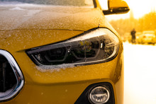 The Image In Front Of The Yellow SUV Car Scene Behind As The Sun Going Up With Snowflakes In The Right