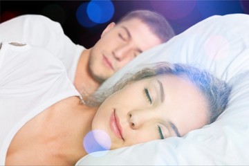 Wall Mural - Beautiful sleeping woman in white bed with flares