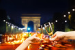 Paris arc de triumph with glasses of champagne